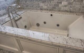 A tub surrounded by marble